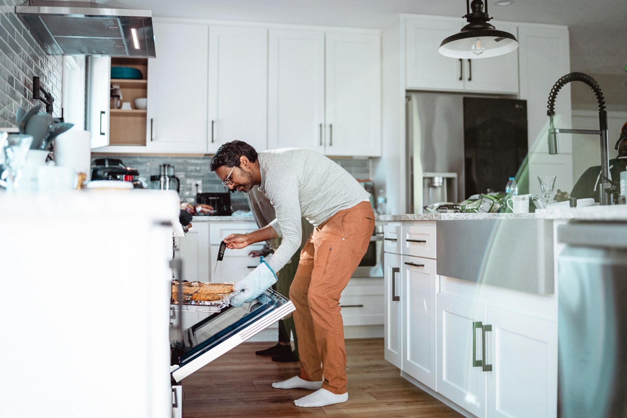 Appliance repair technician in a home kitchen
