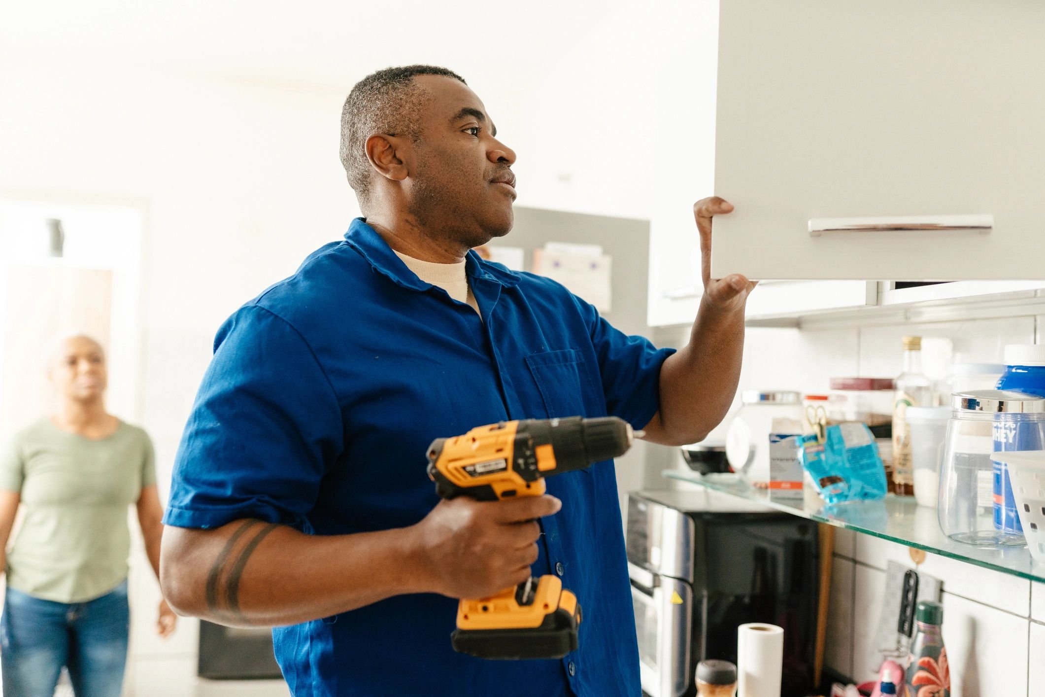 Appliance repair technician working in a residential kitchen